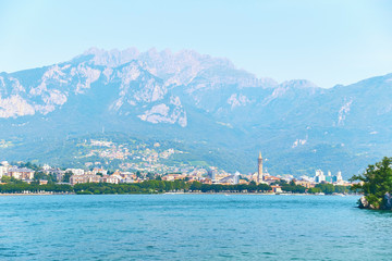 Beautiful summer view of the city of Lecco in Italy on the shore of lake Como with visible famous bell tower of the Basilica of San Nicolo.