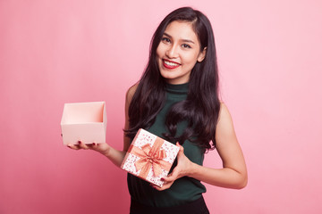 Young Asian woman open a golden gift box.