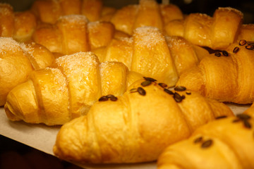 Golden croissants in the shop window