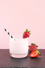 Strawberry milkshake with berry on pink. Close up. Summer food.