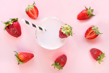 Strawberry milkshake with berry on pink. Close up. Summer drink.