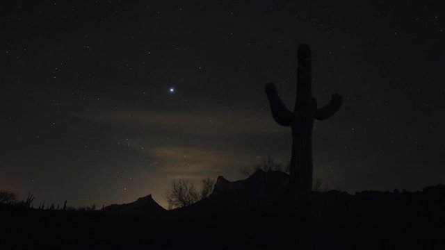 Time lapse of a desert landscape at night with Saguaro cactus and mountains