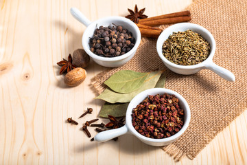 Exotic spices concept Chinese Asian Spices mix  Sichuan peppercorns, star anise pods, bay leave, black peppers, nutmegs, cloves and cinnamon sticks with copy space