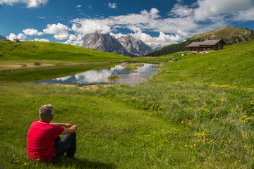 Naklejka na ściany i meble Man is relaxing in the Dolomites