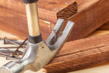 Hammer and nails on wood background