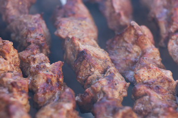 Fresh meat shish kebab fried and smoked on a charcoal grill. Roast the meat close up