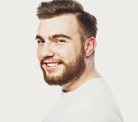 Obraz premium Lifestyle and people concept: Closeup portrait of a happy young man smiling on white background