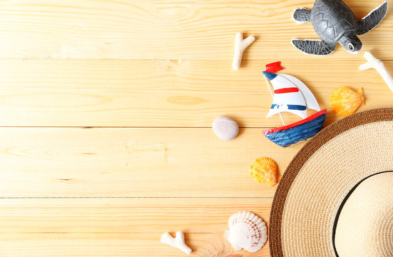 Beach hat,sailboat and glasses on wood background In the summer Asia,copy space,Top view,minimal style