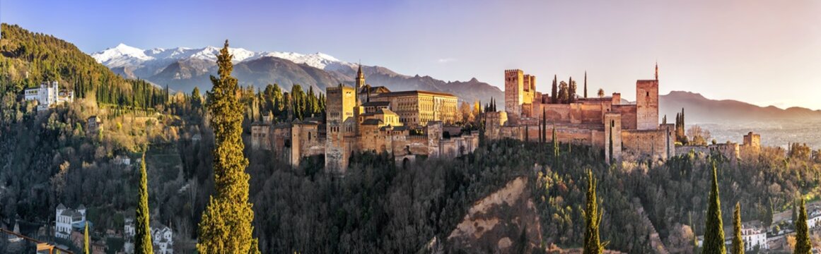 Palace and fortress complex Alhambra with Comares Tower, Palacios Nazaries and Palace of Charles V during sunset in Granada, Andalusia, Spain.