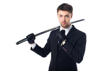 portrait of spy agent in suit and gloves holding katana isolated on white