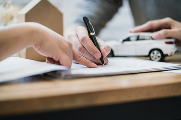 success business contract deasl with sale represent and clients meeting with paper document contract and pen close up on wooden table and background