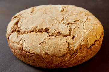 Homemade whole fresh bread close up. Just baked round bread. Side view