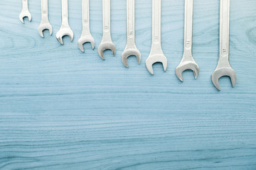 Tools scattered in correct order on blue background. Top view