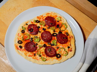 Pepperoni pizza on white plate.