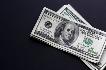 One hungret dollar bills on black background. Cope space