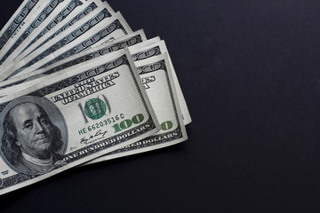 One hungret dollar bills on black background. Cope space
