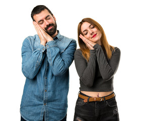 Man and woman making sleep gesture