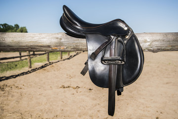 Saddle for horse leather, black, brown, on the fence