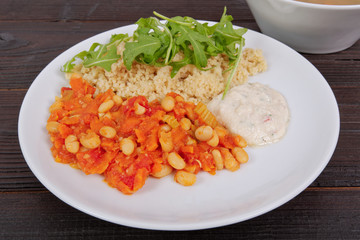 Baked beans and carrot with couscous on a table