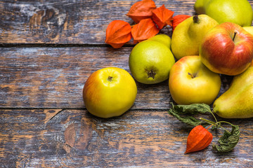 Apples and pears, autumn harvest on wooden background