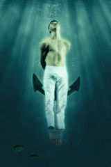 Fototapeta na wymiar Man floats underwater