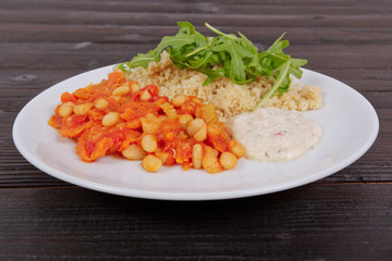Baked beans and carrot with couscous on a table