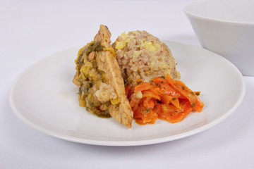 Tempeh with leek and mash on a white