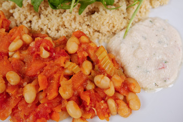 Baked beans and carrot with couscous on a white