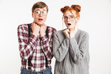 Scared couple of school nerds looking at camera