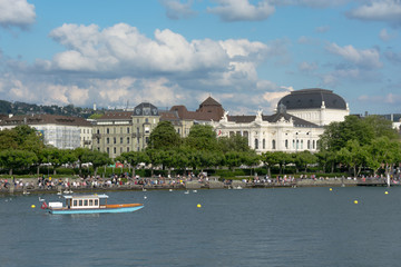 Fototapeta na wymiar Zurich lake with boat. View of historic Zurich city center with Zurich Opera House, Switzerland. Summer