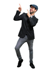 Handsome modern man with beret and glasses pointing with the index finger a great idea