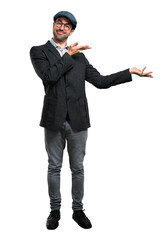 Handsome modern man with beret and glasses presenting and inviting to come