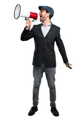 Fototapeta premium Handsome modern man with beret and glasses holding a megaphone