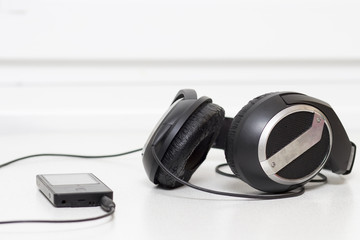 Obraz na płótnie Canvas Black headphones and player.