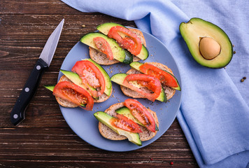 Toast with avocado and tomato slices