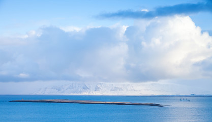 Coastal Icelandic landscape with cargo ship
