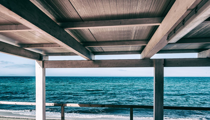 Fototapeta na wymiar View of sardinian beach from a wooden terrace