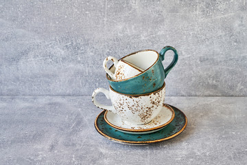 Obraz na płótnie Canvas Tea cups stack on gray background.