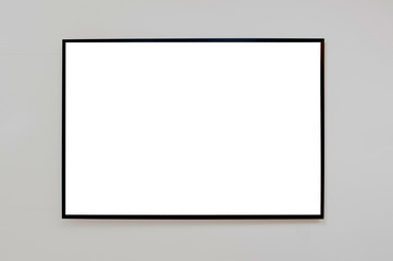 Mock up black frame for picture, advertisement or poster on a gray wall