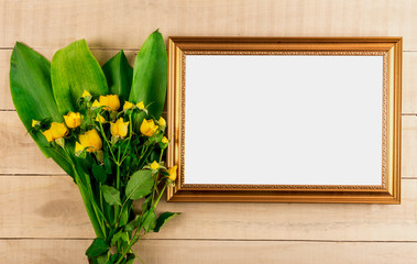 photo frame and bouquet of yellow dwarf roses