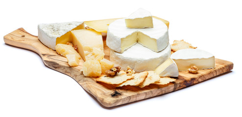 Brie cheese on a wooden Board with nuts and bread