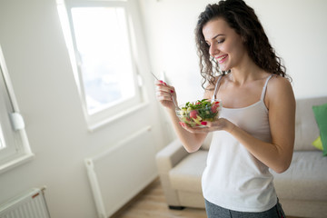 Fitness woman eating healthy food after workout