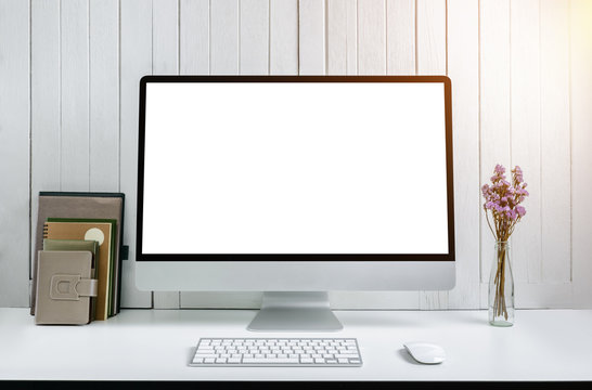 workplace background with Blank white screen modern desktop computer. White wooden vintage blackground