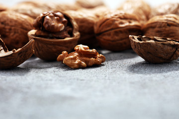 Walnut kernels and whole walnuts on rustic old table
