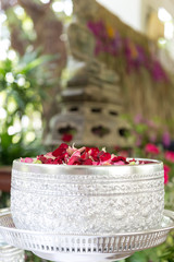 Water with jasmine and roses corolla in bowl for Songkran festival in Thailand.