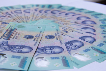 Vietnamese money dong on white table. VND. Just printed asian money. Asian money fan out. Concept of rich and sucsess.