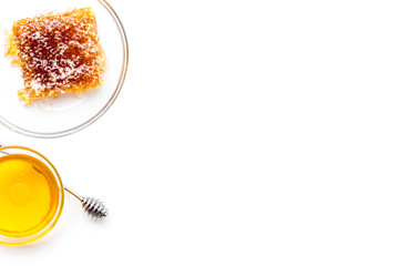 Apiary products. Honey in bowl and honeycomb on white background top view copy space
