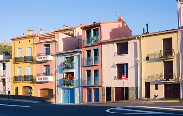 Fototapeta na wymiar Colourful houses in street and flag of Catalonia, Colliure. Pyrenees-Orientales. Languedoc Roussillon. France