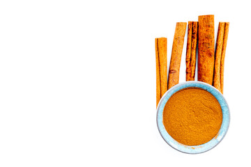 Cinnamon seasoning. Sticks and powder on white background top view copy space