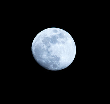 Blue moon on a black background at night